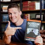 Russell Brunson holding dotcom secrets